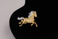 Golden Galloping Horse Brooch with Silver-Tone Mane
