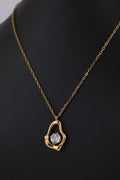 Gold-Tone Sculptural Pendant Necklace with Crystal Accent