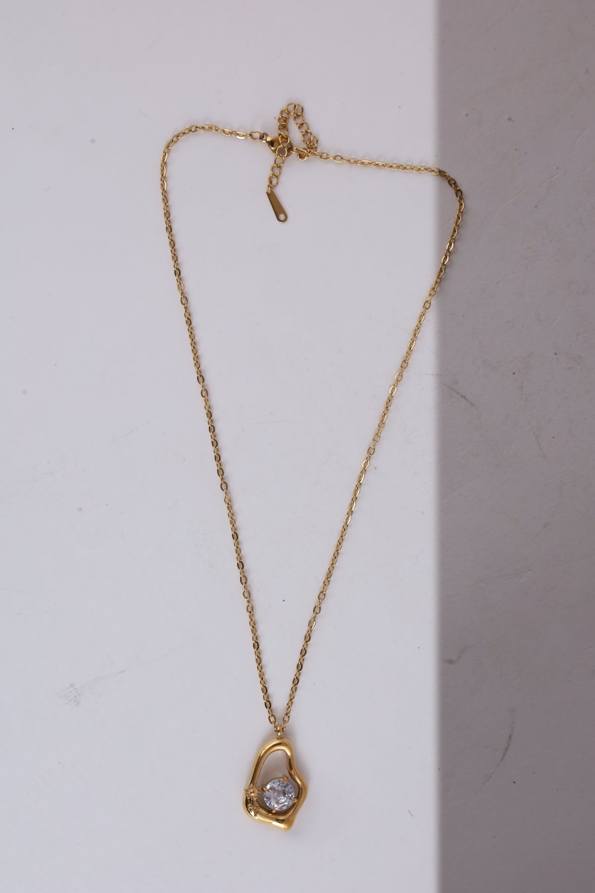 Gold-Tone Sculptural Pendant Necklace with Crystal Accent